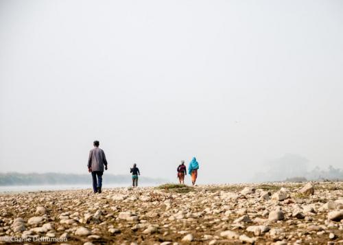 People going to take the boat to cross the river